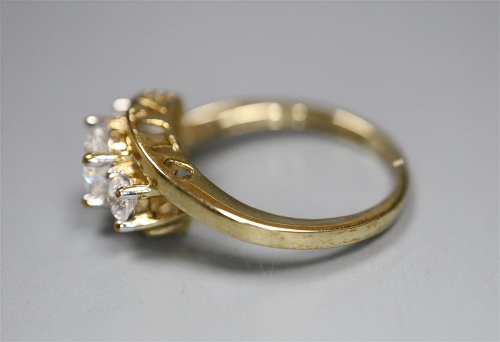 A 9ct gold and simulated diamond three stone ring, size J, gross 1.9 grams.